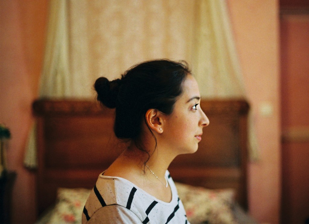 profile portrait of girl in a pink room